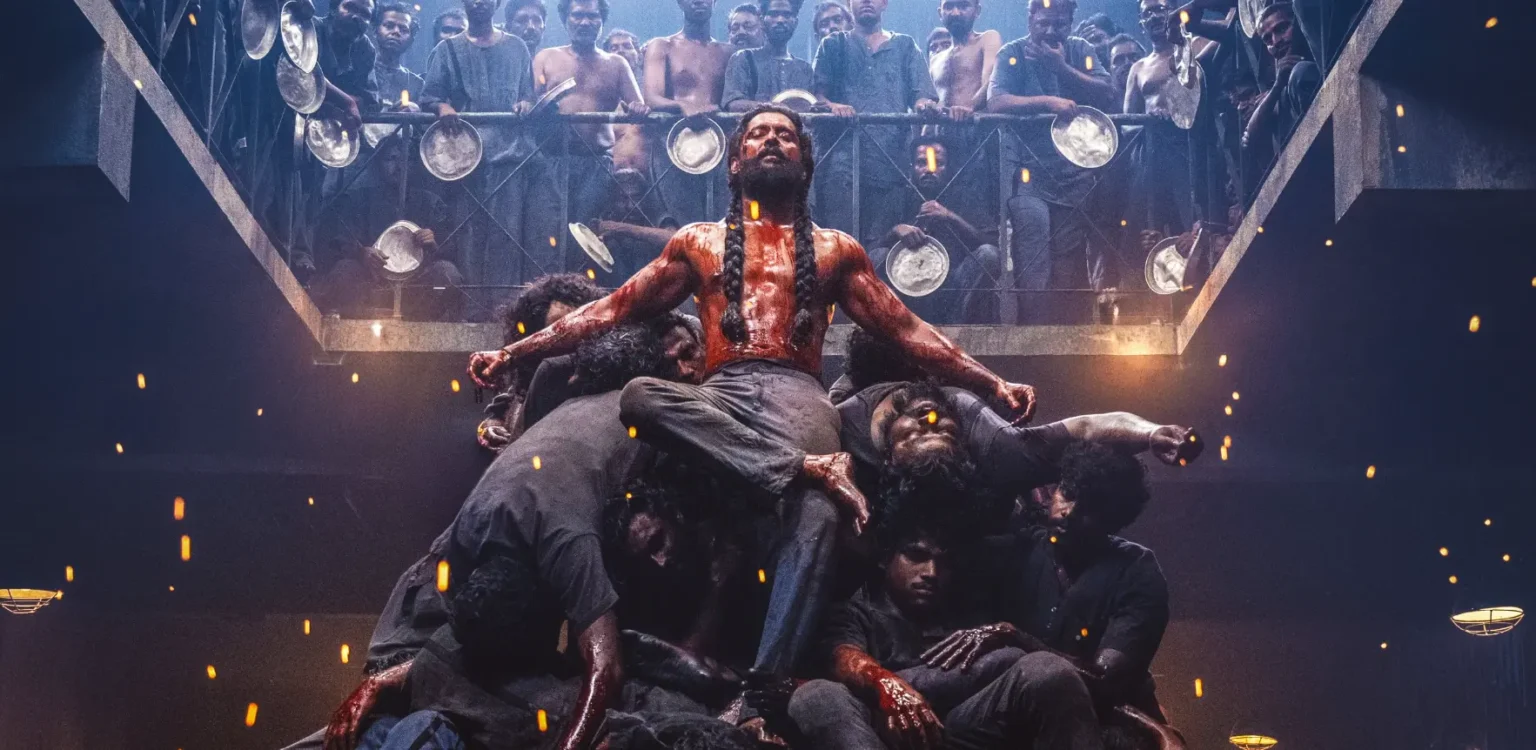 నాని ‘ది ప్యారడైజ్’ టీజర్: రక్తం చిందించేలా, ఇంటెన్స్ వర్షన్ లో… మనం ఇప్పటివరకూ చూడని కొత్త నాని! Natural star Nani as muscular, blood-stained man with long braided hair sitting triumphantly atop a pile of defeated men in a prison gallery in The Paradise movie.